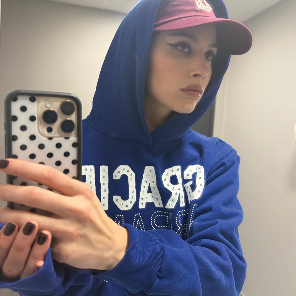 Gracie wearing Gracie Abrams Letter Repeat Navy Unisex Hoodie